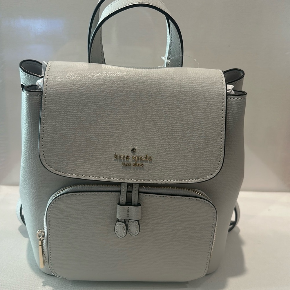NWT Kate Spade Medium Flip Backpack in Refined Grain Gray Kristi w/snap closure.